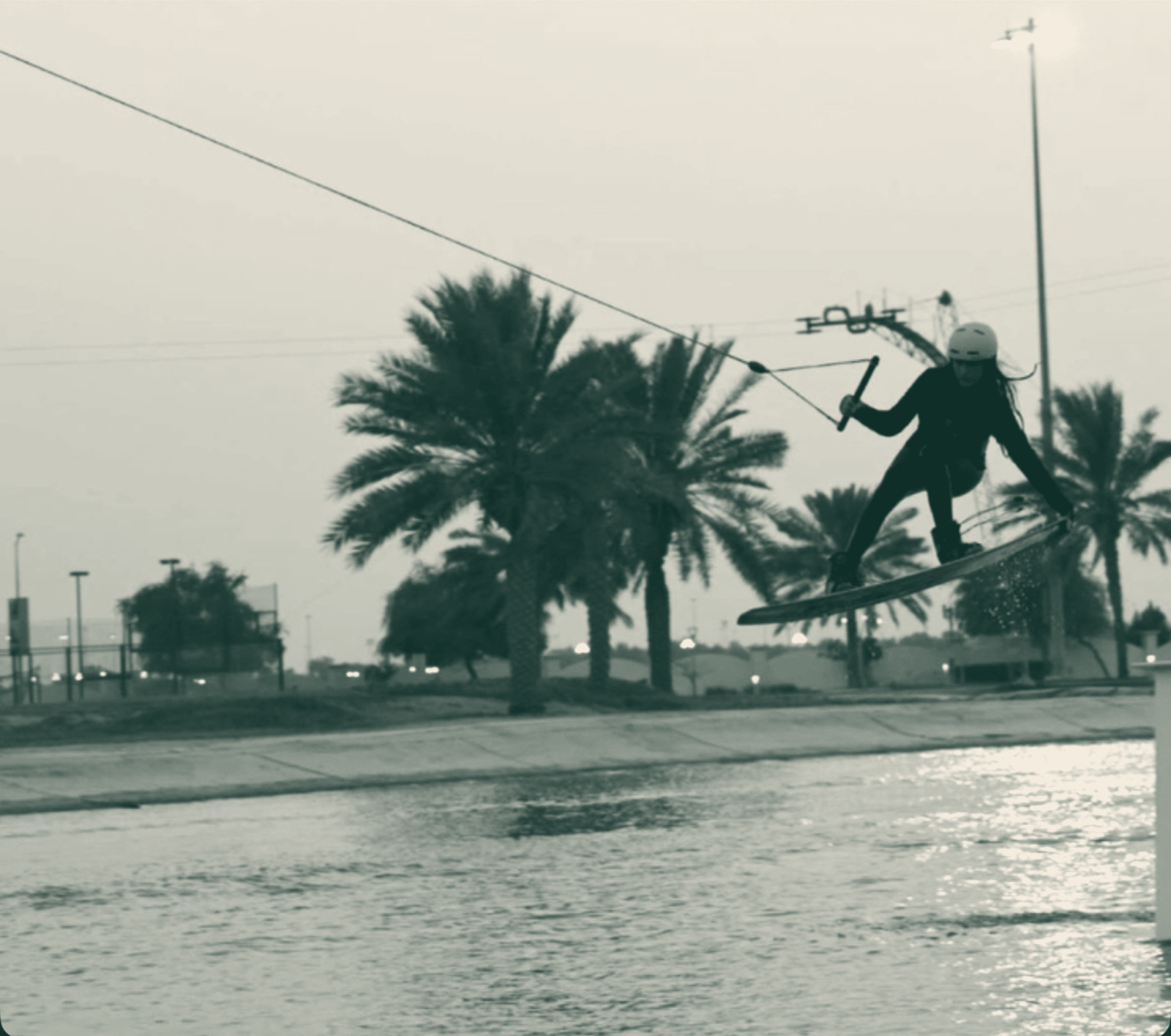 Me riding the cable at Al Forsan at dusk, palms behind me