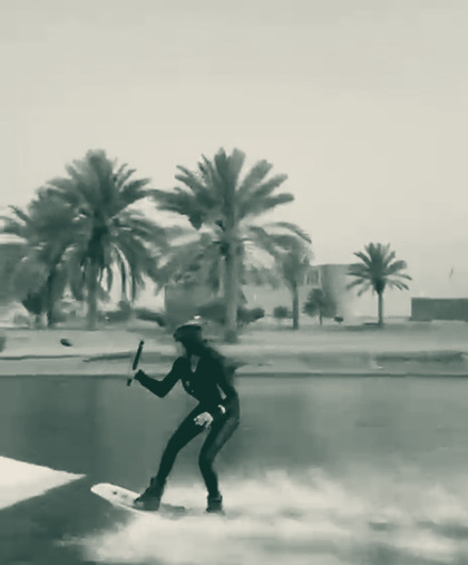 Me riding toward the kicker, spray off the board